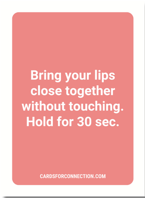 Pink card with white text on a white background: "Bring your lips close together without touching."