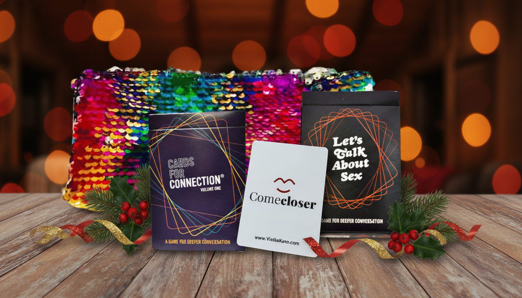 Three decks with a sequin sparkle bag, Cards for Connection, Come Closer, and Let's Talk About Sex on a wooden table with holiday decorations.