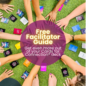 A colorful top-down view of diverse hands reaching toward a circle of Cards for Connection® on vibrant green grass. A purple circle overlay reads “Free Facilitator Guide – Get even more out of your Cards for Connection® deck.