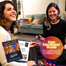 Load image into Gallery viewer, Two women smiling and playing Cards for Connection® in a cozy living room. An overlay promotes the “Free Facilitator Guide – Get even more out of your Cards for Connection® deck,” with a visual preview of the guide pages in the foreground.