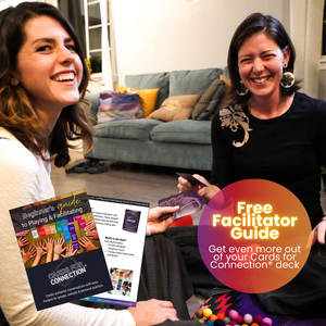 Two women smiling and playing Cards for Connection® in a cozy living room. An overlay promotes the “Free Facilitator Guide – Get even more out of your Cards for Connection® deck,” with a visual preview of the guide pages in the foreground.