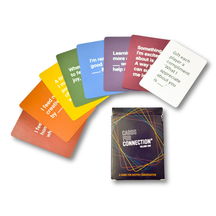 Rainbow spread of Cards for Connection® conversation cards with the tuck box on a white background — showing all eight color-coded themes from Games for Humanity.