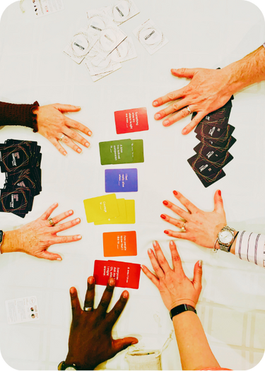 cards for connection on white table with diverse hands reaching in