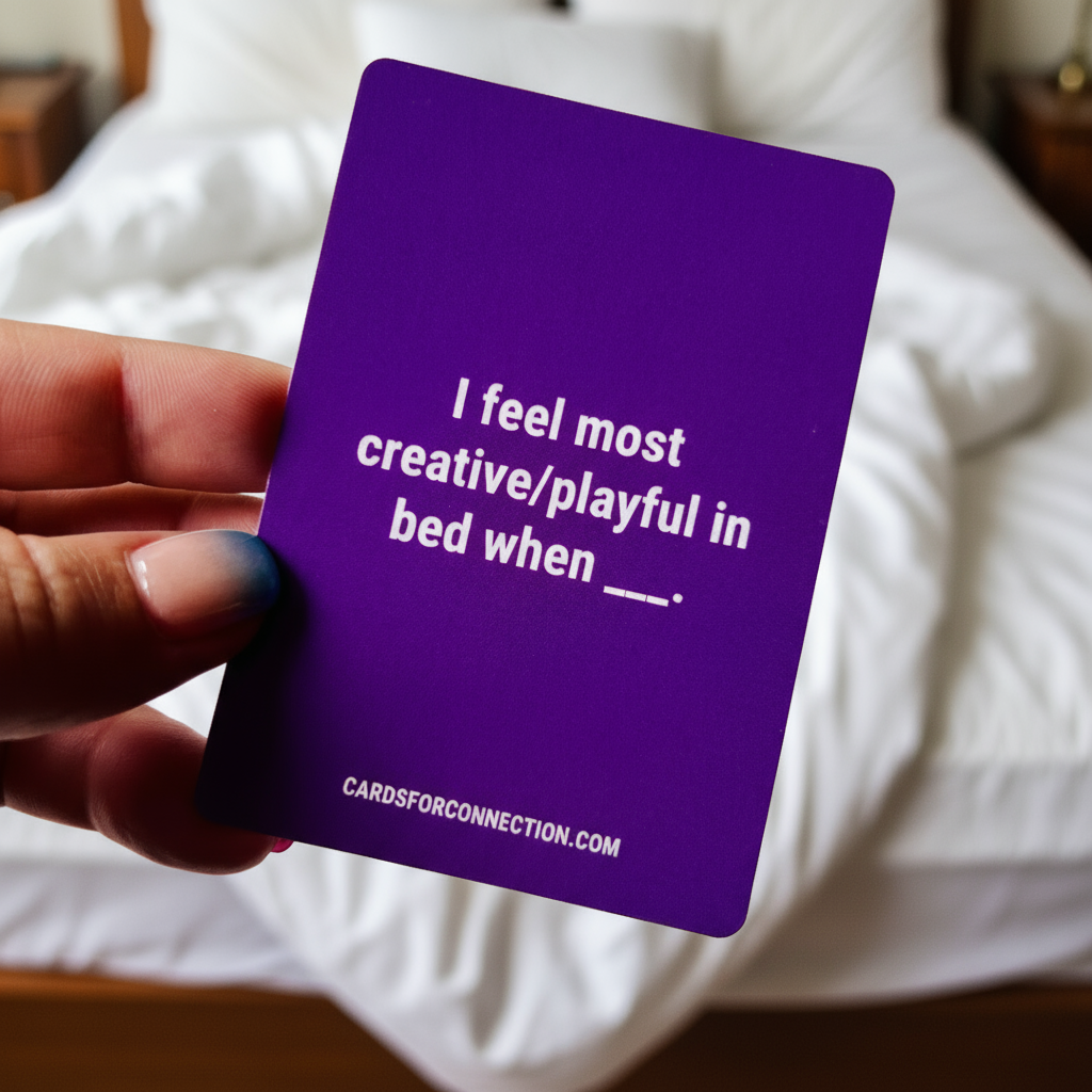 Purple Come Closer card from the Playful Soul intimacy style. Held by a hand with a bed in the background. I feel most creative/playful in bed when ___. 