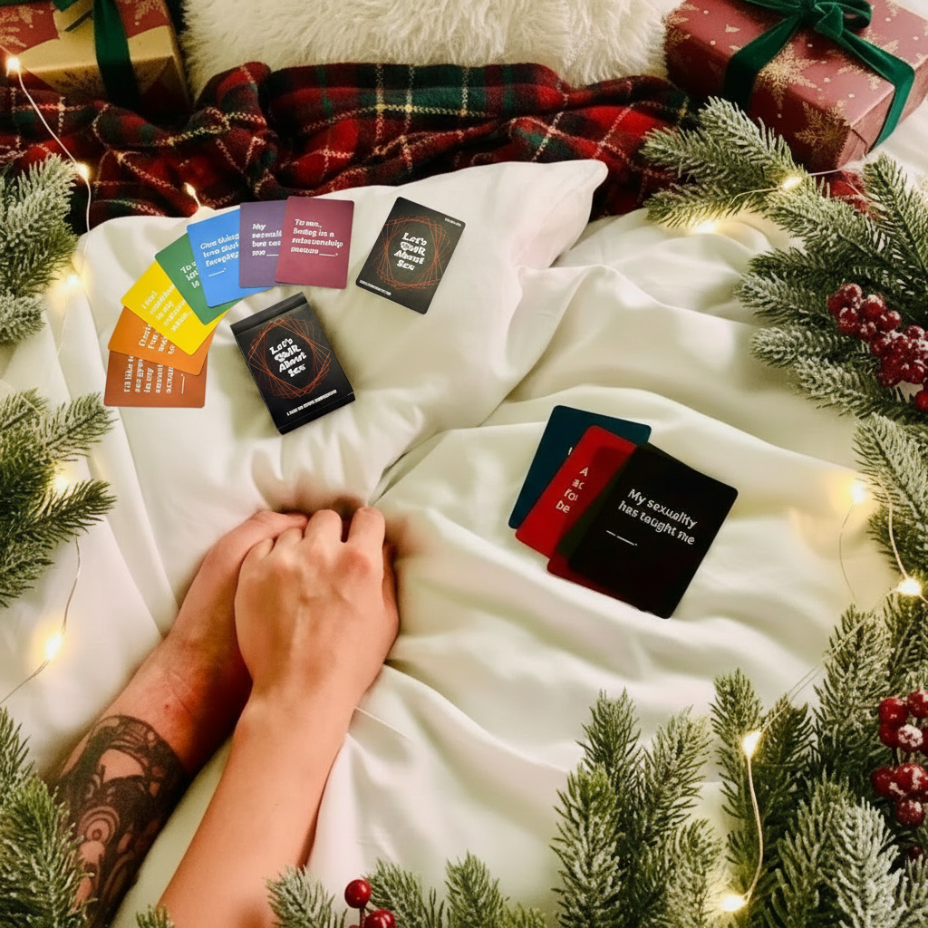 Two hands holding a deck of cards  surrounded by holiday gifts.