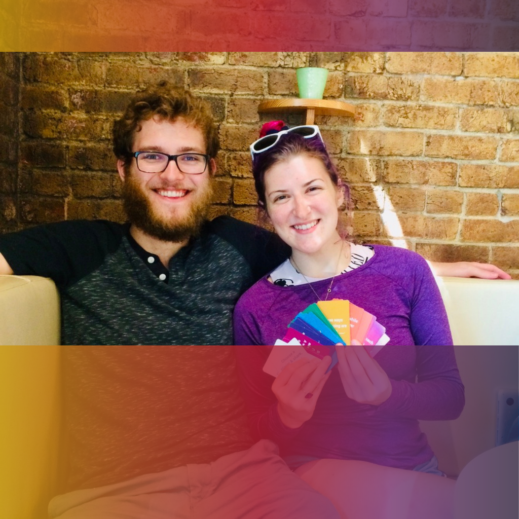 A smiling couple holding Cards for Connection during a fun date-night moment.