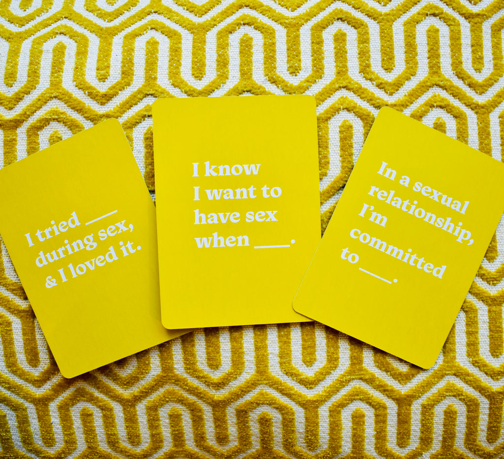 Three yellow Let’s Talk About Sex cards showing prompts about sexual preferences and commitment.