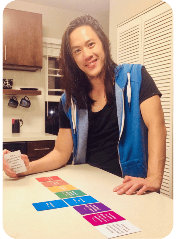 Person smiling while laying out Cards for Connection on a kitchen counter.