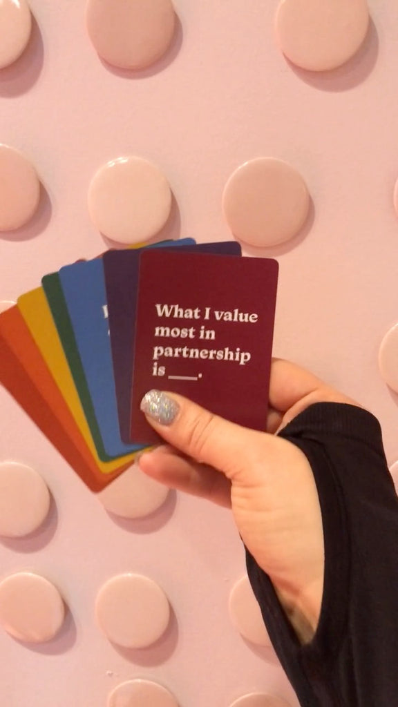 Video of Let’s Talk About Sex cards displayed on a pink background.