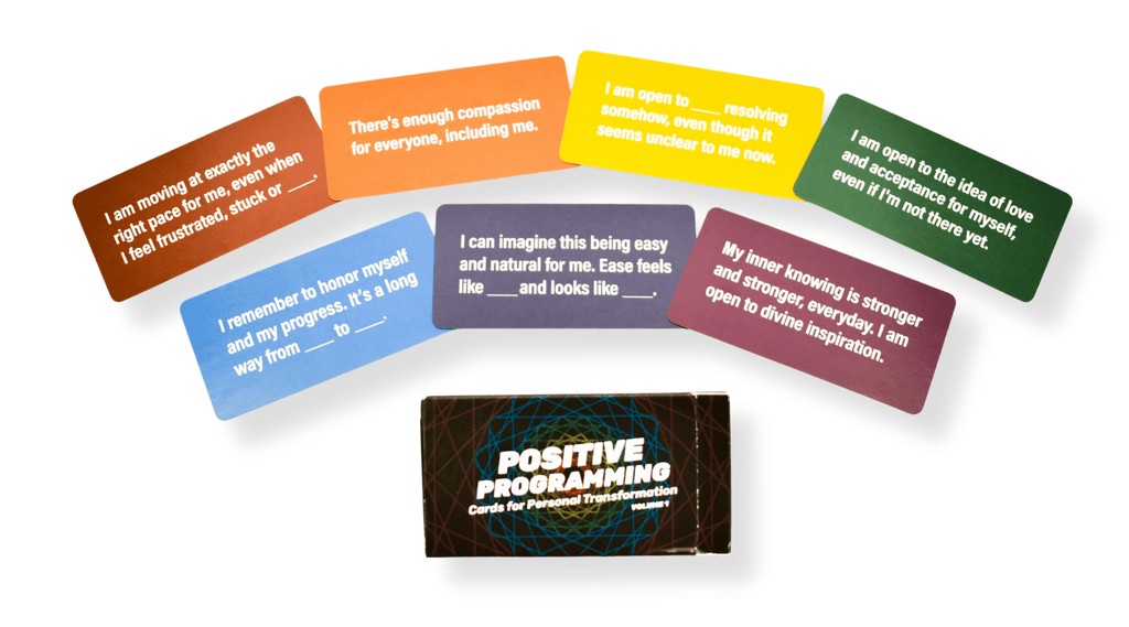Positive Programming cards arranged in a rainbow fan with the deck box in the center.