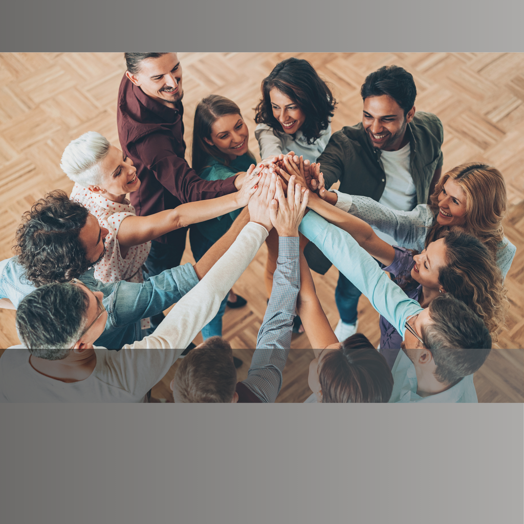 Alt text:
 Coworkers in a team huddle, representing workplace team-building and trust-building environments.