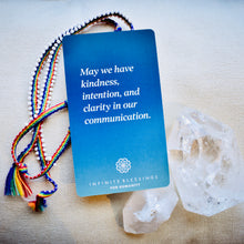 Load image into Gallery viewer, Infinite Blessings Deck - Games for Humanity Blue card with crystals and rainbow bracelet for an intention setting healing session 