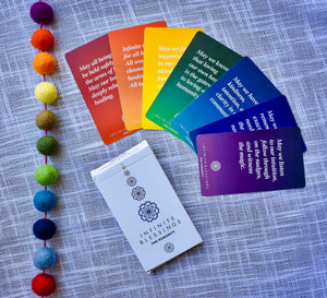 Infinite Blessings Deck - Games for Humanity Close-up of rainbow color-coded cards from the Infinite Blessings Deck, highlighting chakra associations